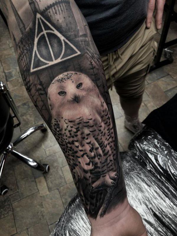Realistic owl and deathly hallows forearm tattoo