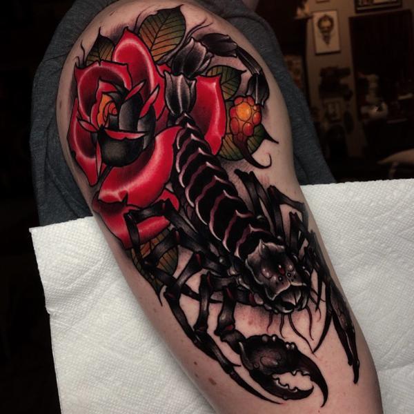 Realistic scorpion and rose on the upper arm