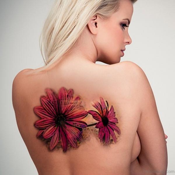 Red daisy back tattoo