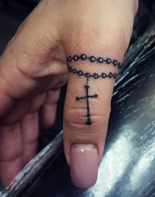 Rosary tattoo on finger