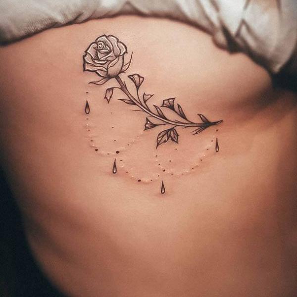 Rose with pendant side boob tattoo