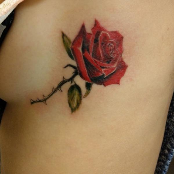 Rose with thorns side boob tattoo