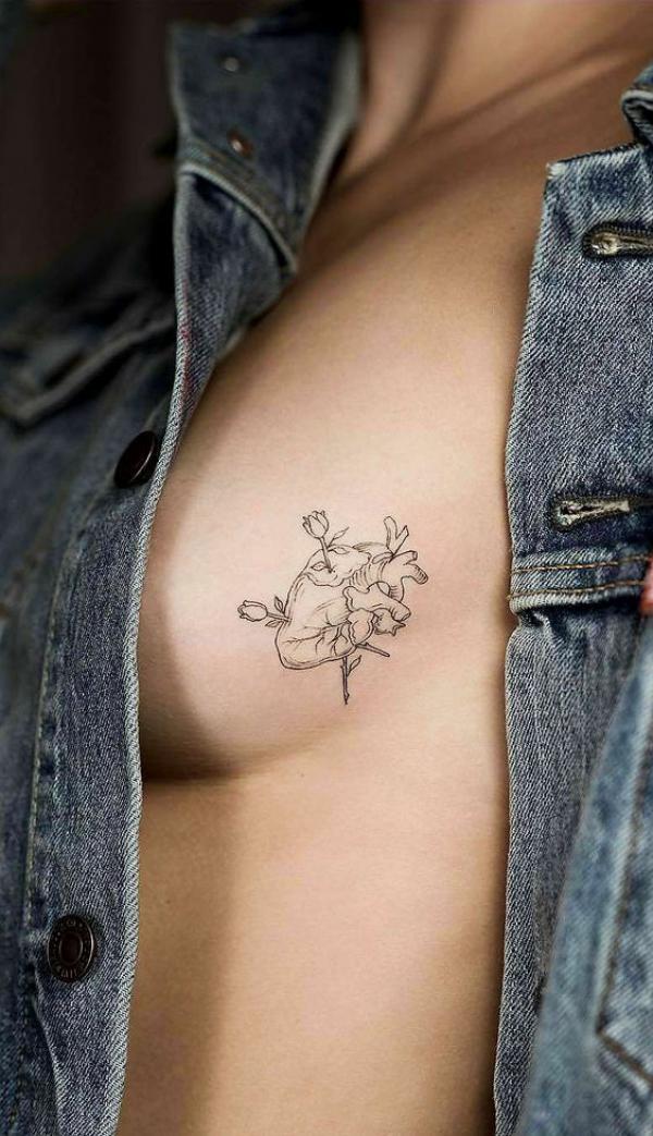 Roses through heart side boob tattoo