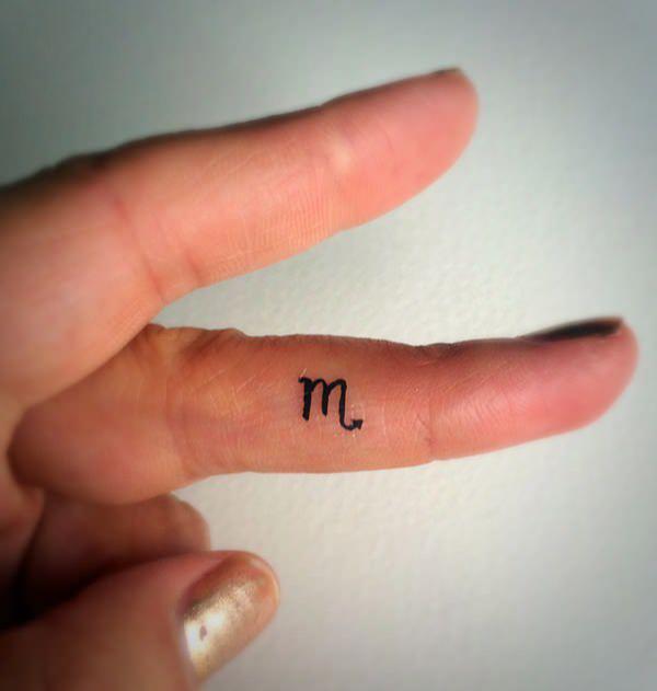 Scorpio glyph finger tattoo