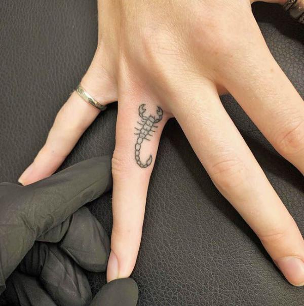 Scorpion finger tattoo