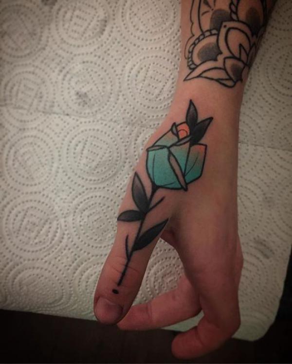Simple blue rose above thumb