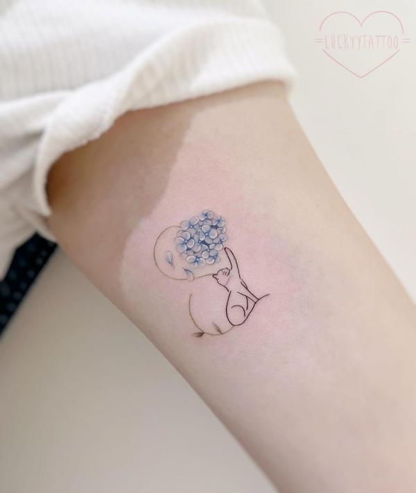 Simple cat outline and dainty hydrangea tattoo