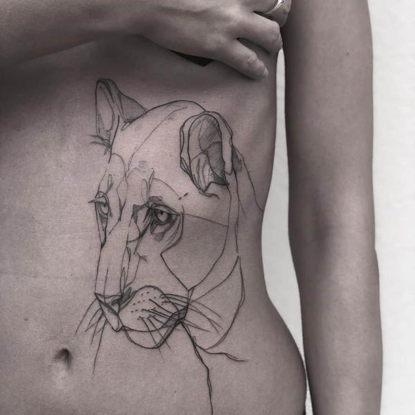 Simple lioness line work tattoo