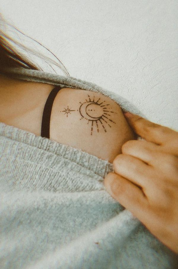 Simple sun and moon shoulder tattoo