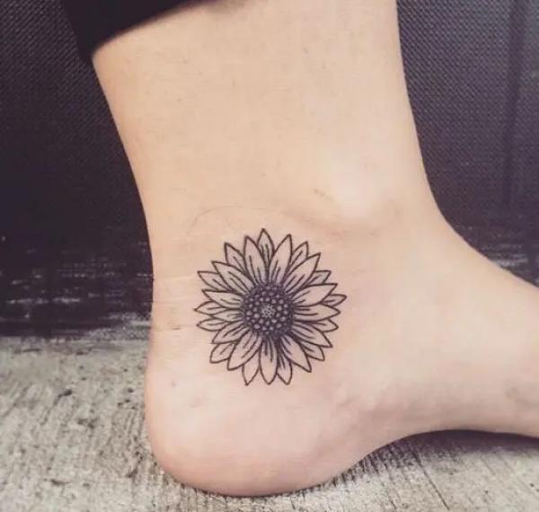 Single daisy ankle tattoo
