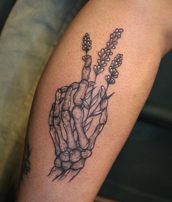 Skeleton hand holding lavender flower