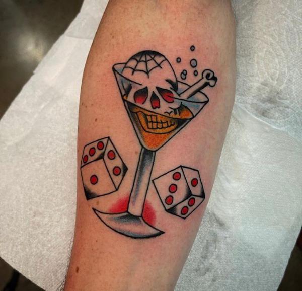 Skull in glass with dices tattoo