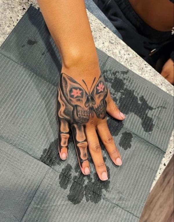 Skull moth and skeleton finger tattoo