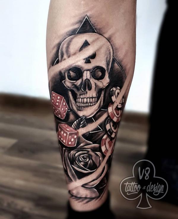 Skull rose and dice tattoo