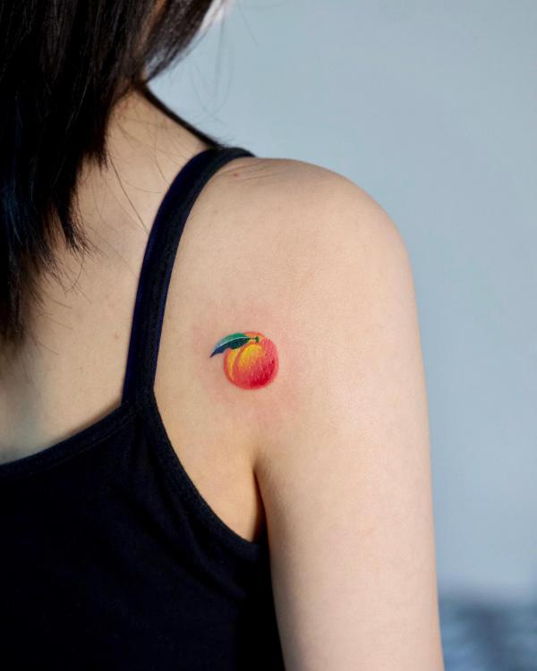 Small Peach shoulder blade tattoo