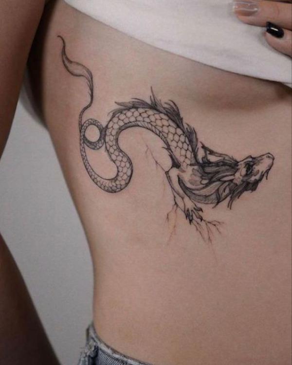 Small dragon side boob tattoo