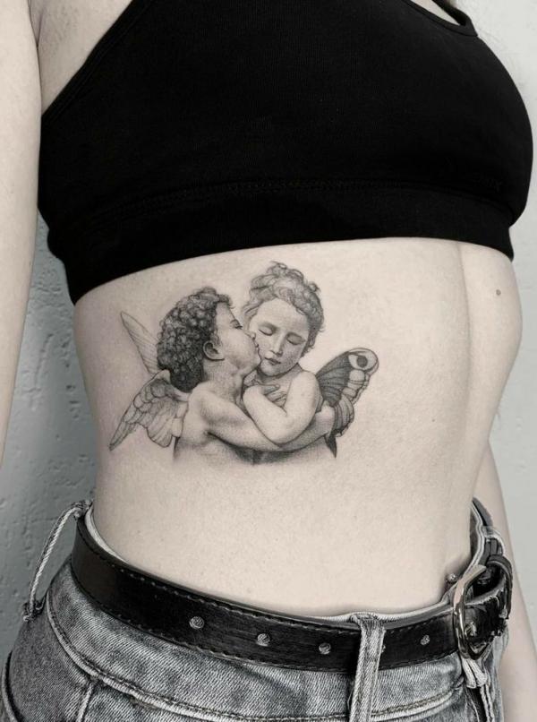 Small kissing cupid tattoo side