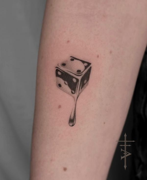 Small melting dice tattoo