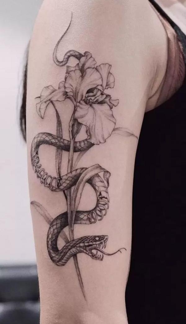 Snake and Iris upper arm tattoo