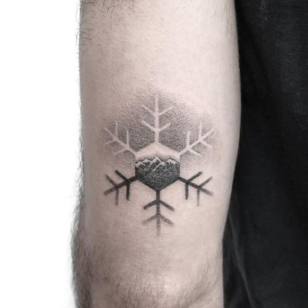 Snowflake dotwork upper arm tattoo