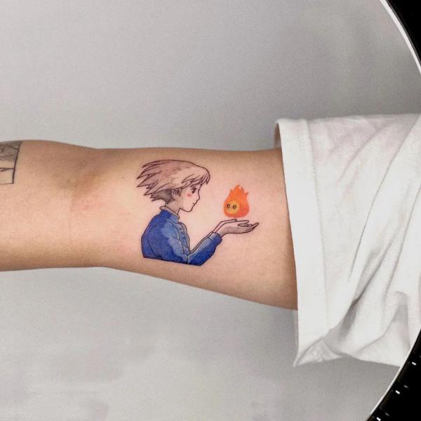 Sophie catching calcifer bicep tattoo