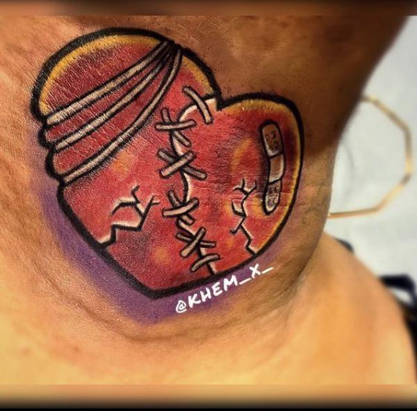 Stitched broken heart with bandaid neck tattoo