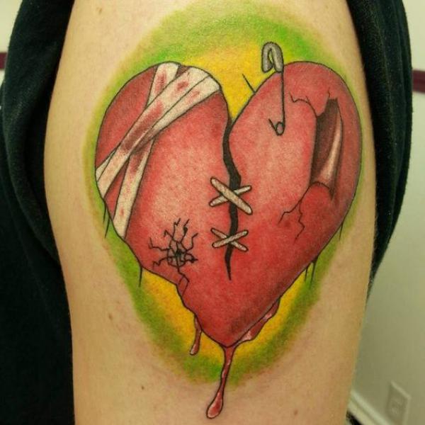 Stitched broken heart with broken heart safety pin tattoo