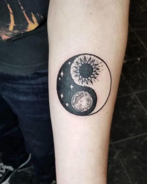 Sun and moon Yin Yang tattoo on inner forearm