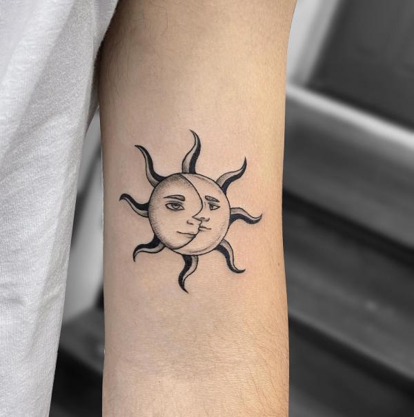 Sun and moon bicep tattoo
