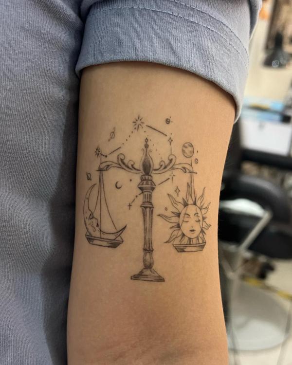 Sun and moon face Libra and constellation upper arm tattoo 1