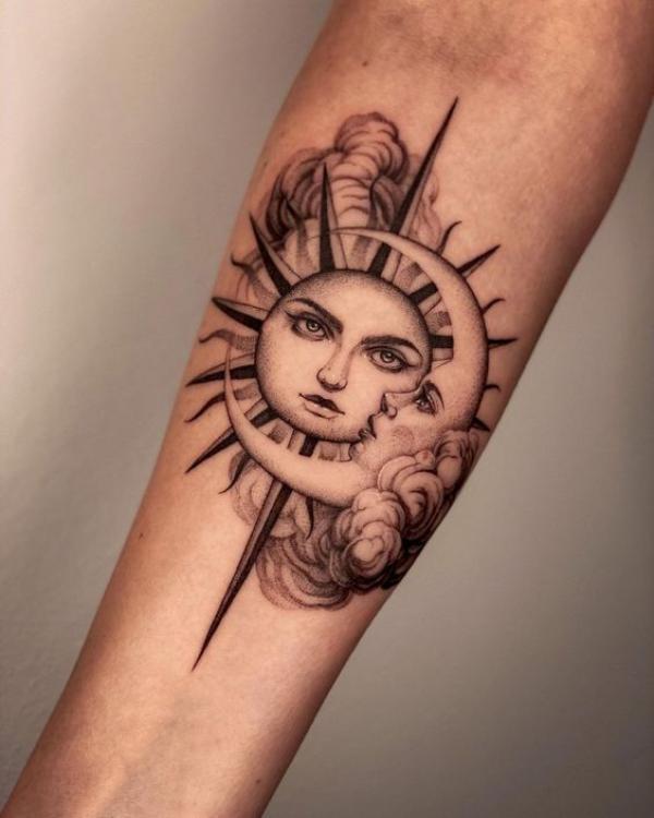 Sun and moon face forearm tattoo