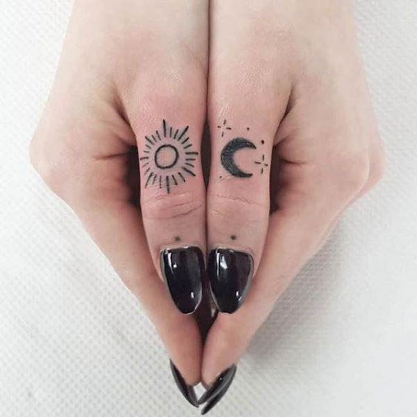 Sun and moon finger tattoo