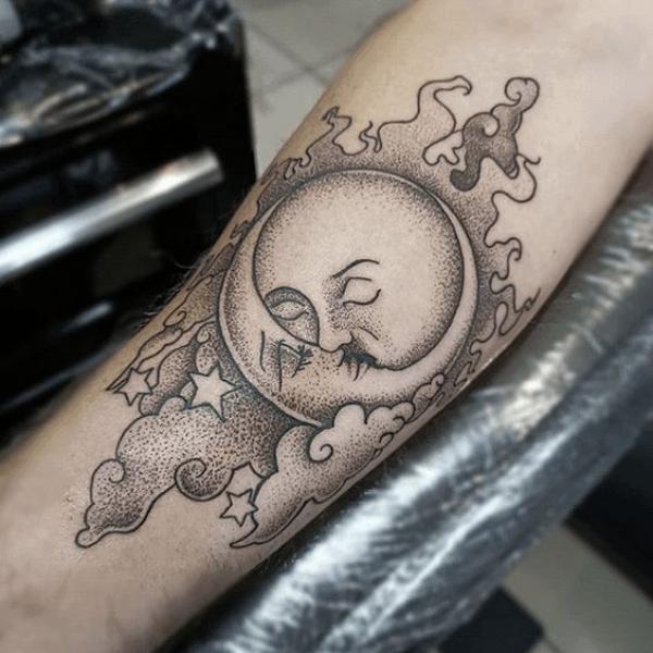 Sun and moon in clouds tattoo