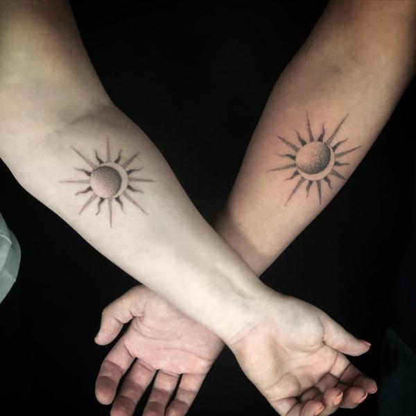 Sun and moon matching couple tattoo on forearm