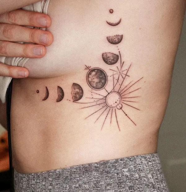 Sun and moon phases side boob tattoo