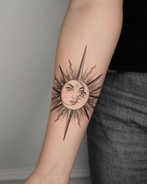 Sun and moon tattoo on inner forearm