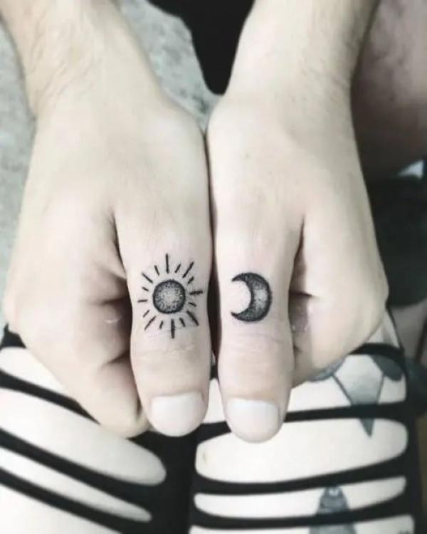 Sun and moon thumb finger tattoo