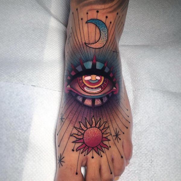 Sun and moon with eye tattoo on foot