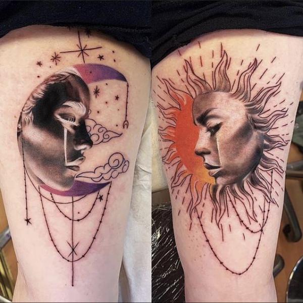 Sun with the face of a man and a moon with the face of a woman thigh tattoo