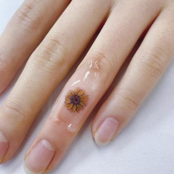 Sunflower finger tattoo