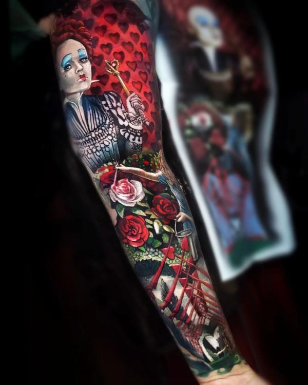 The queen of hearts in flowers arm tattoo