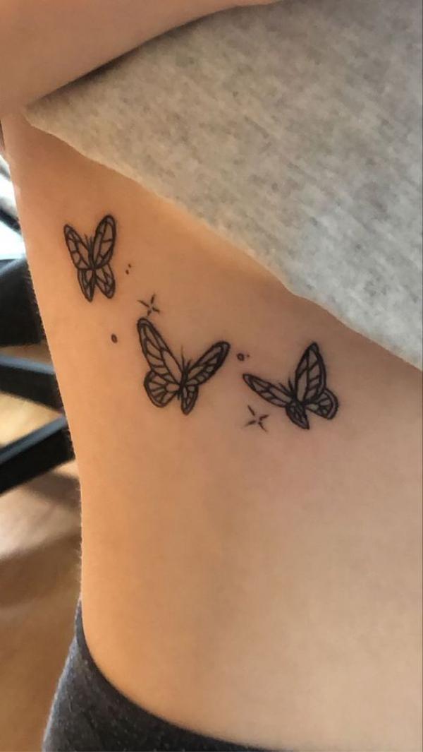 Three butterflies with stars side boob tattoo