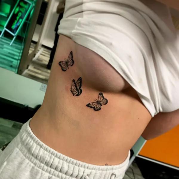 Three butterfly side boob tattoo