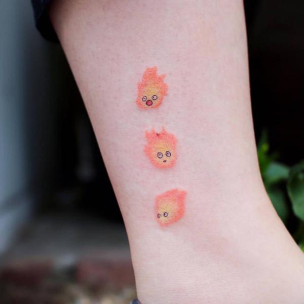 Three dainty Calcifer tattoo