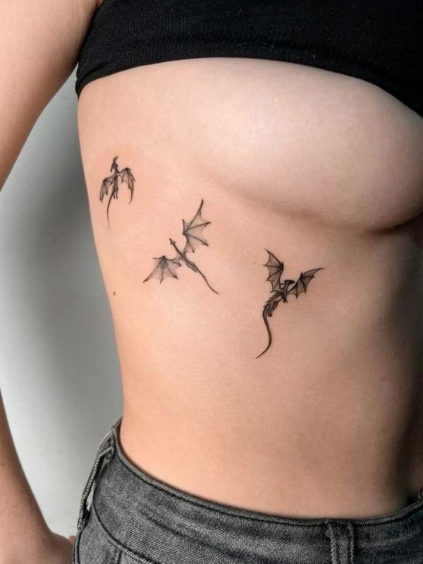Three little dragon side boob tattoo