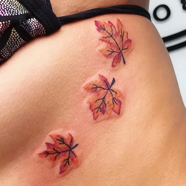Three maple leaves side boob tattoo