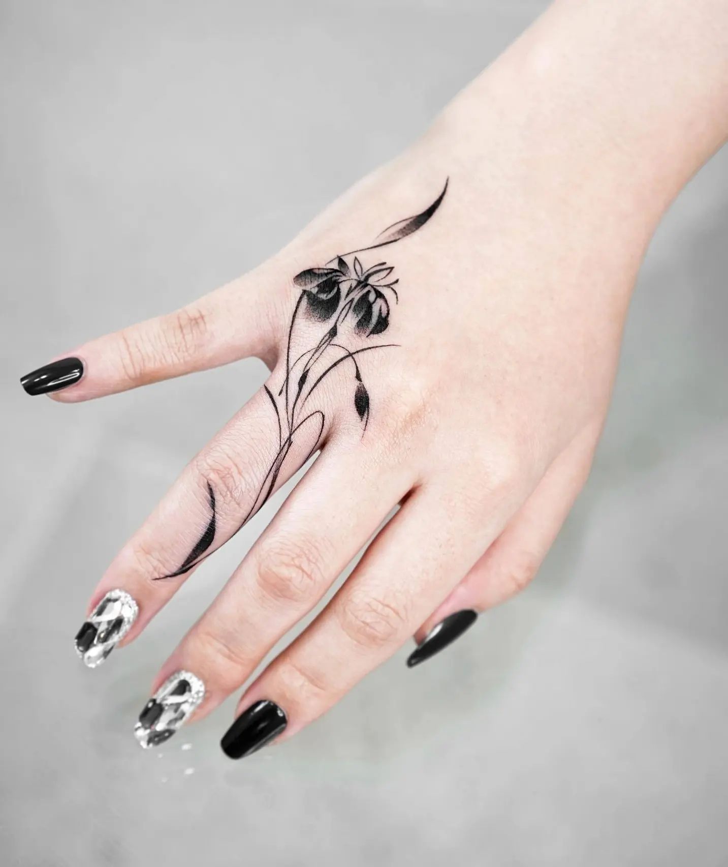 Black and white iris finger tattoo