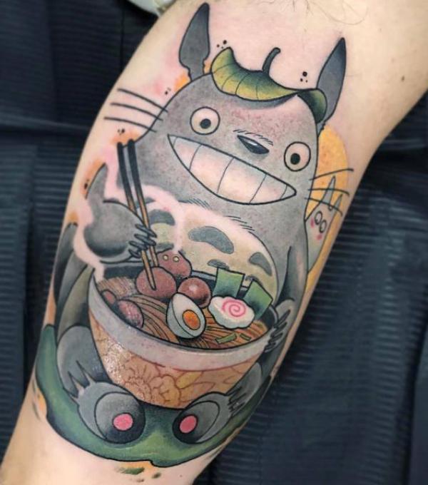 Totoro holding a bowl eating tattoo