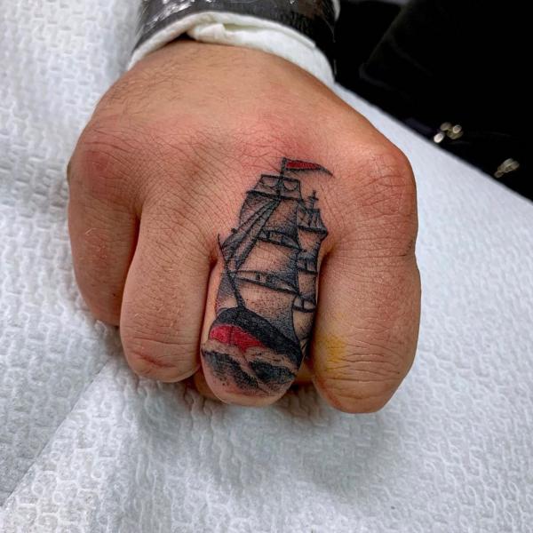 Traditional sailing boat finger tattoo