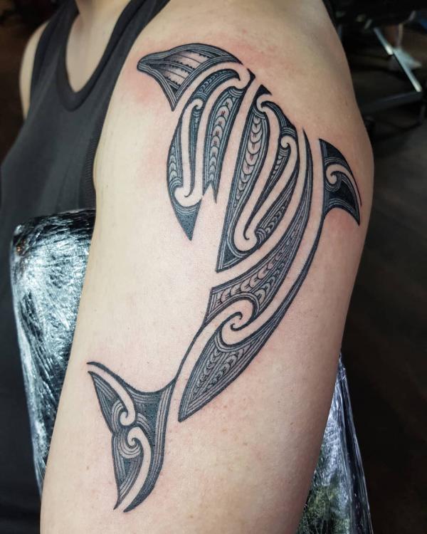 Tribal dolphin upper arm tattoo